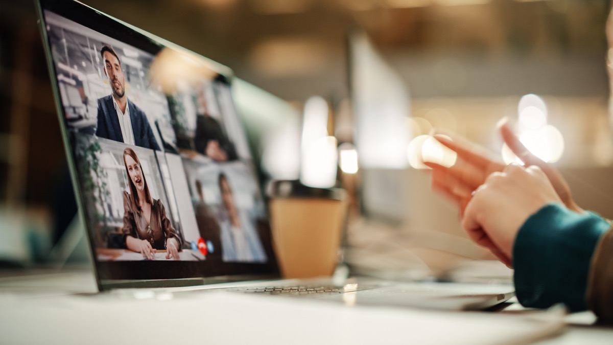 Laptop screen showing a four-person video call